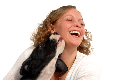 woman laughing with puppy